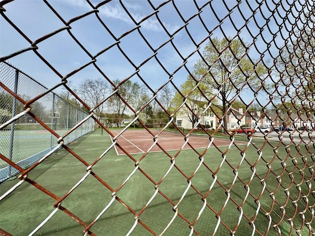 view of sport court featuring fence