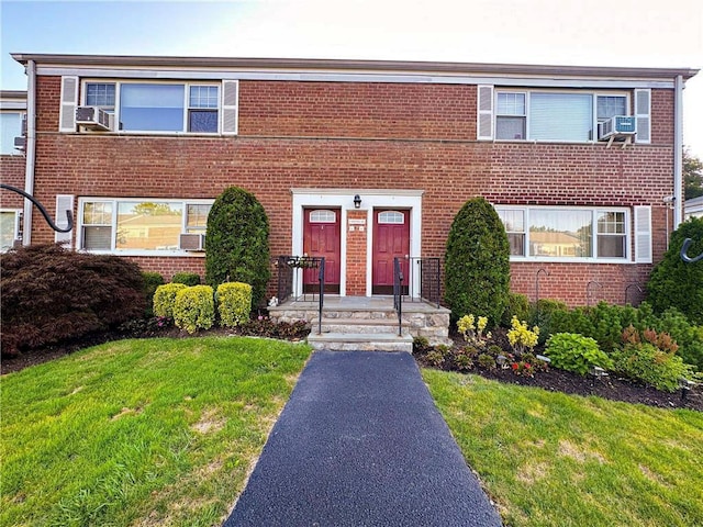 11 Westview Ave Unit 16-2, White Plains, NY 10603 - view of property featuring brick siding, cooling unit, and a front lawn