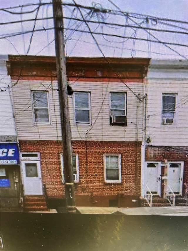 exterior space with entry steps and brick siding