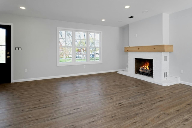 21 Kent Rd, Hopewell Junction, NY 12533 - unfurnished living room featuring a fireplace, wood finished floors, plenty of natural light, and recessed lighting