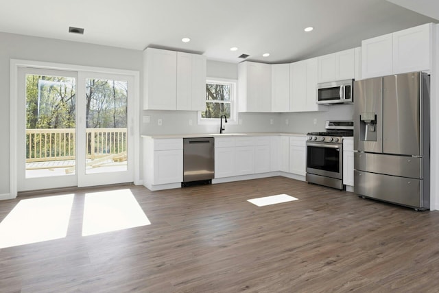 21 Kent Rd, Hopewell Junction, NY 12533 - kitchen with dark wood-style floors, a sink, white cabinetry, light countertops, and appliances with stainless steel finishes