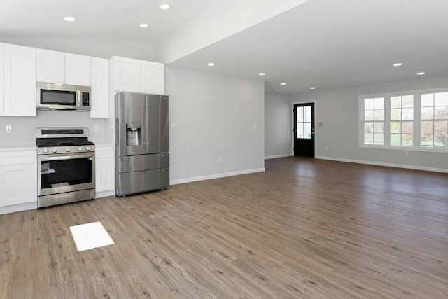 21 Kent Rd, Hopewell Junction, NY 12533 - kitchen featuring white cabinetry, stainless steel appliances, open floor plan, and light wood finished floors