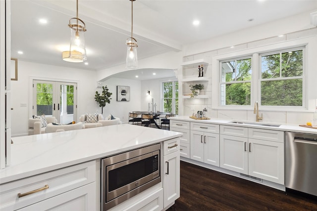 53 Jay St, Katonah, NY 10536 - kitchen featuring stainless steel appliances, a sink, dark wood finished floors, open floor plan, and hanging light fixtures