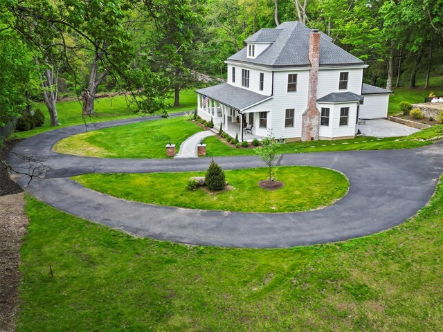 53 Jay St, Katonah, NY 10536 - view of front of house with a porch, a shingled roof, a chimney, curved driveway, and a front yard