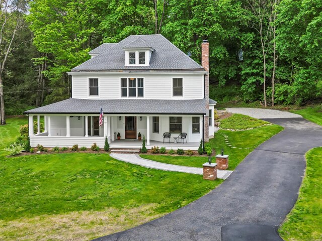 53 Jay St, Katonah, NY 10536 - view of front of home with a shingled roof, a porch, a chimney, asphalt driveway, and a front lawn
