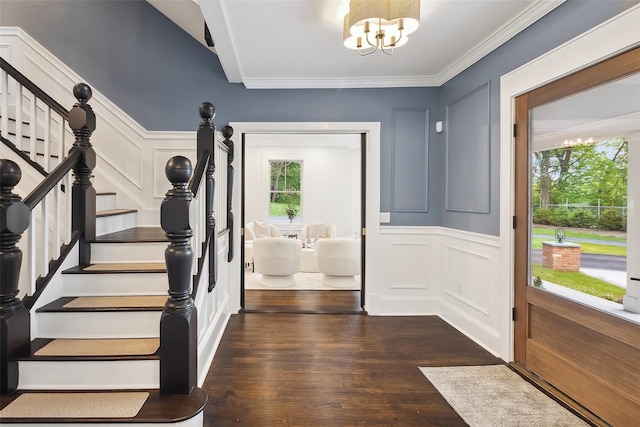 53 Jay St, Katonah, NY 10536 - entryway with a decorative wall, a chandelier, stairs, dark wood finished floors, and crown molding