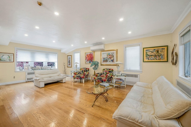 living room with radiator heating unit, ornamental molding, light wood-style floors, and a wall mounted AC