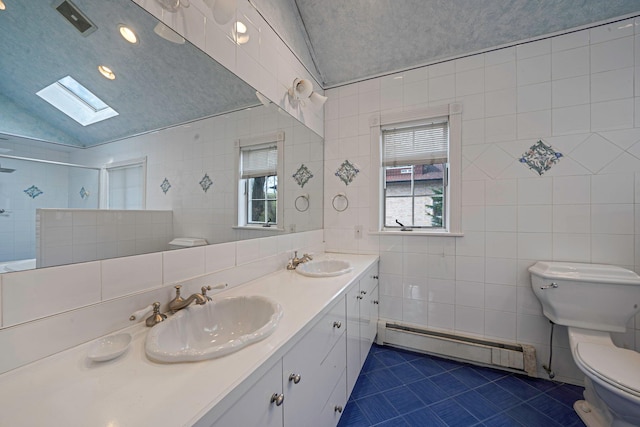 bathroom featuring a baseboard heating unit, toilet, a sink, and tile patterned flooring