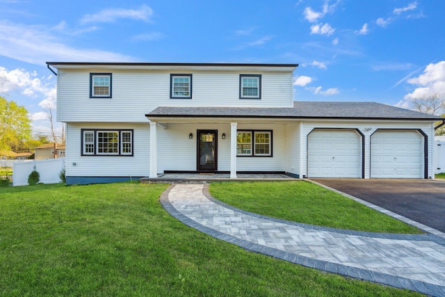 view of front of home with aphalt driveway, fence, a front yard, an attached garage, and a porch