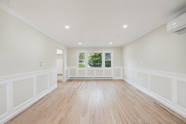 unfurnished room with wainscoting, light wood-style floors, an AC wall unit, and baseboard heating