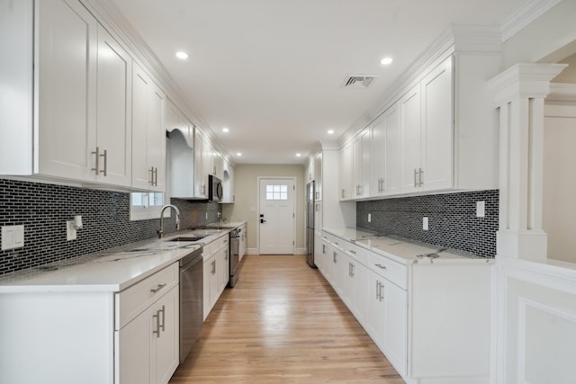 kitchen with visible vents, light wood-style floors, recessed lighting, white cabinets, and appliances with stainless steel finishes