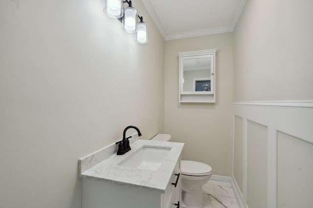 bathroom with crown molding, toilet, marble finish floor, and vanity