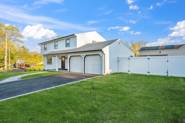 view of front of house featuring fence, an attached garage, aphalt driveway, a front yard, and a gate