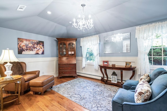 28 Stepping Stone Cres, Dix Hills, NY 11746 - living area with a chandelier, wood finished floors, vaulted ceiling, a wainscoted wall, and baseboard heating