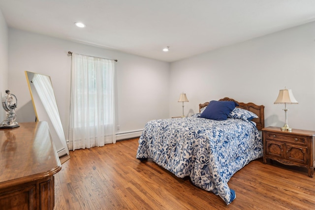 28 Stepping Stone Cres, Dix Hills, NY 11746 - bedroom featuring baseboard heating, wood finished floors, recessed lighting, and a baseboard radiator