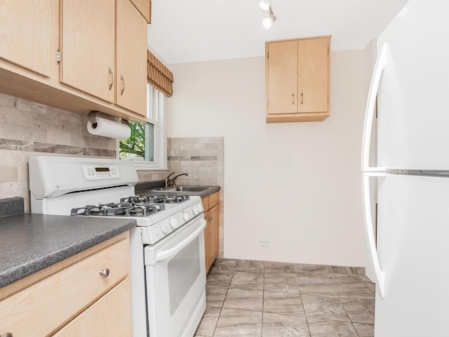 77 Hilltop Acres Unit 77, Yonkers, NY 10704 - kitchen featuring a sink, tasteful backsplash, light brown cabinetry, white appliances, and dark countertops