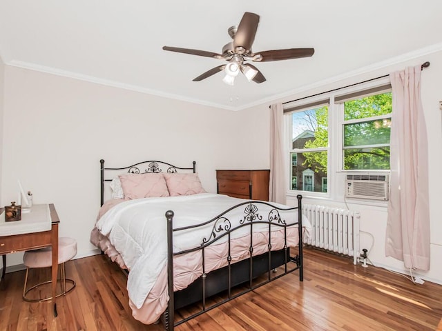 77 Hilltop Acres Unit 77, Yonkers, NY 10704 - bedroom featuring cooling unit, radiator heating unit, ornamental molding, and wood finished floors