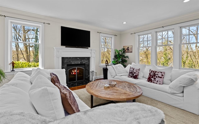 living room with crown molding, a high end fireplace, and recessed lighting