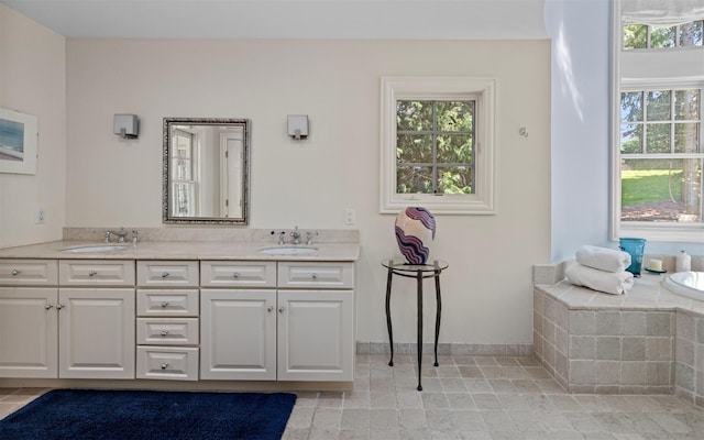bathroom featuring double vanity, a sink, and a wealth of natural light