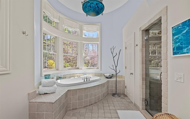 full bathroom with a garden tub, tile patterned flooring, and a stall shower