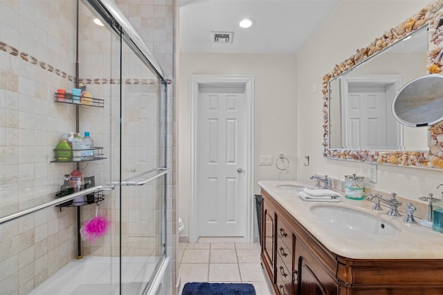bathroom with visible vents, a shower with door, tile patterned flooring, and a sink
