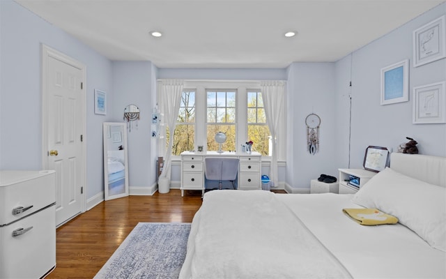 bedroom featuring wood finished floors, recessed lighting, and baseboards
