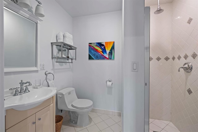 full bathroom with a shower stall, baseboards, toilet, tile patterned floors, and vanity
