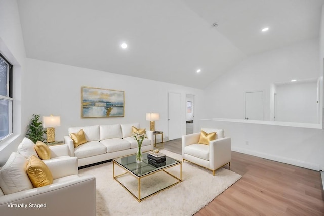 living area with baseboards, recessed lighting, wood finished floors, and lofted ceiling