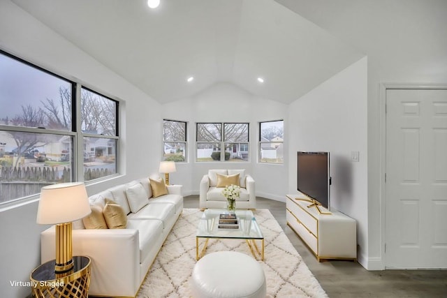 living room with recessed lighting, wood finished floors, lofted ceiling, and baseboards