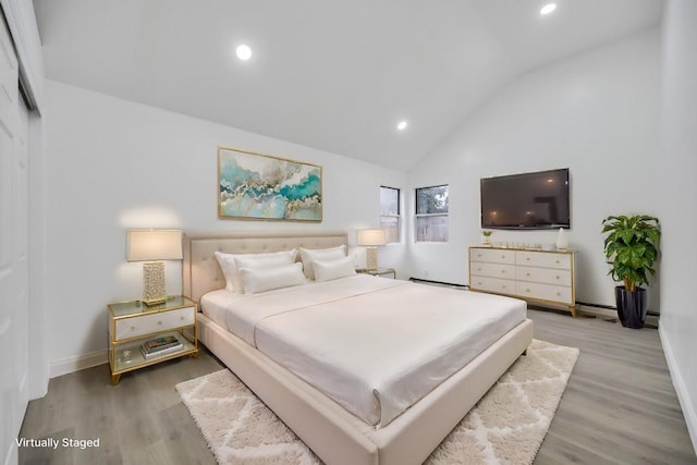 bedroom with recessed lighting, light wood-style flooring, vaulted ceiling, and baseboards