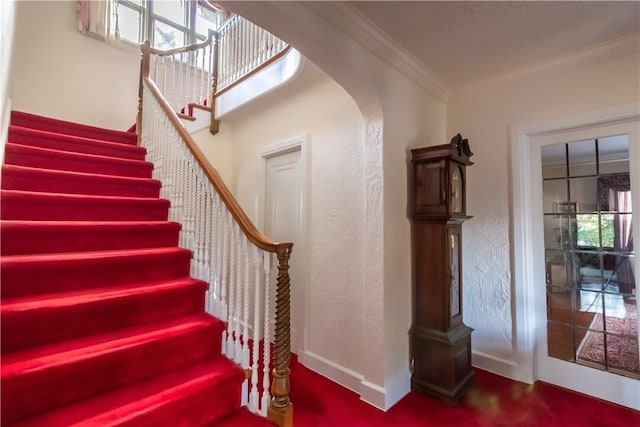 130 E Cedar St, Mount Vernon, NY 10552 - staircase featuring crown molding, arched walkways, and baseboards