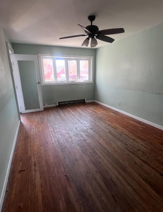 119 Broadfield Rd, Hempstead, NY 11550 - empty room with a baseboard radiator, wood finished floors, ceiling fan, and baseboards