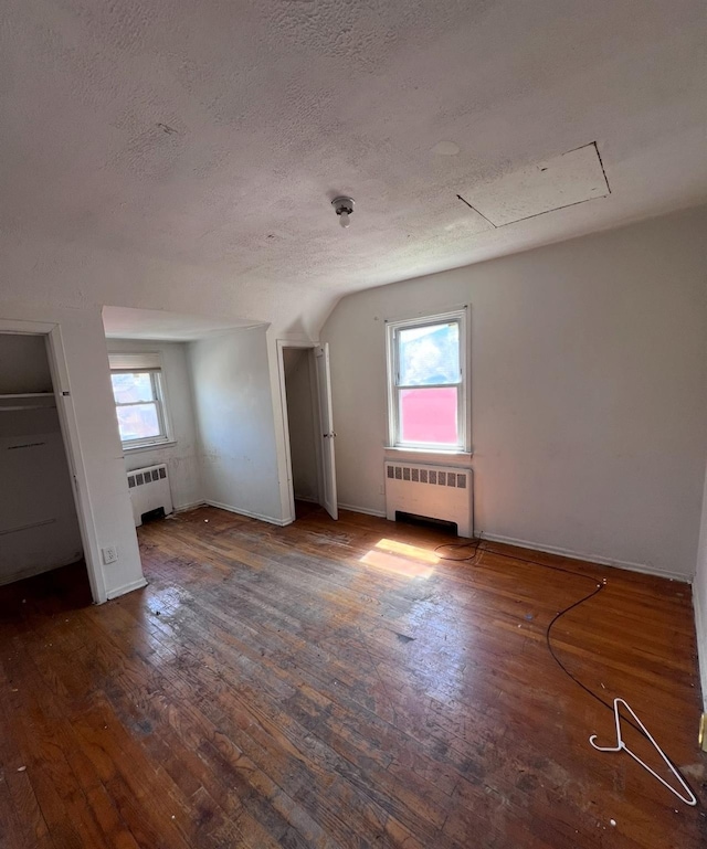 119 Broadfield Rd, Hempstead, NY 11550 - bonus room featuring hardwood / wood-style floors, baseboards, radiator, and a textured ceiling