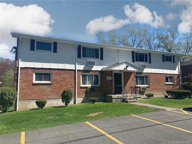 1404 Parr Lake Dr Unit 14D, Newburgh, NY 12550 - view of front of property featuring uncovered parking, a front lawn, board and batten siding, and brick siding