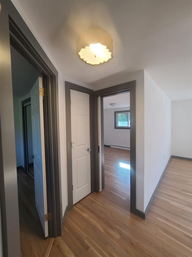 1404 Parr Lake Dr Unit 14D, Newburgh, NY 12550 - hallway with baseboards, baseboard heating, and wood finished floors