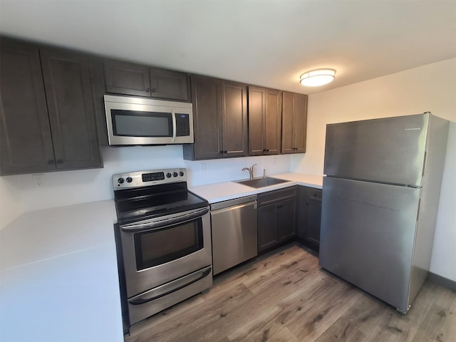 1404 Parr Lake Dr Unit 14D, Newburgh, NY 12550 - kitchen with appliances with stainless steel finishes, light wood-style floors, light countertops, and a sink