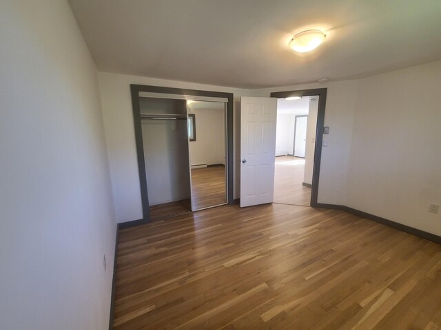 1404 Parr Lake Dr Unit 14D, Newburgh, NY 12550 - unfurnished bedroom featuring wood finished floors, baseboards, and a closet