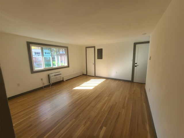 1404 Parr Lake Dr Unit 14D, Newburgh, NY 12550 - unfurnished room with wood finished floors, a baseboard heating unit, electric panel, a wall mounted AC, and baseboards