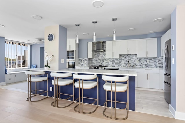18 Shady Glen Ct Unit 302, New Rochelle, NY 10805 - kitchen featuring white cabinets, a sink, light countertops, wall chimney exhaust hood, and decorative backsplash