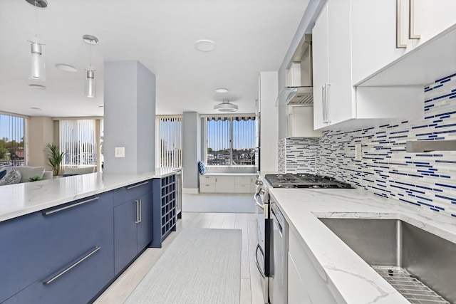 18 Shady Glen Ct Unit 302, New Rochelle, NY 10805 - kitchen with stainless steel gas range, tasteful backsplash, a wealth of natural light, and blue cabinets