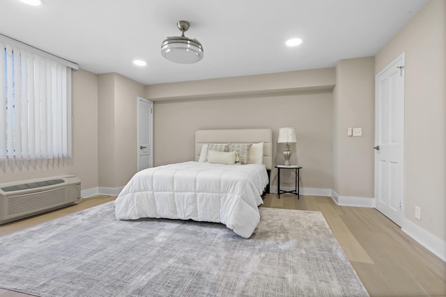18 Shady Glen Ct Unit 302, New Rochelle, NY 10805 - bedroom featuring baseboards, an AC wall unit, recessed lighting, and wood finished floors