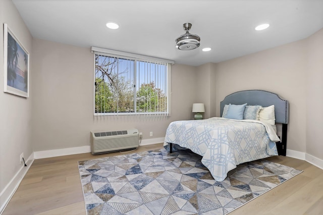 18 Shady Glen Ct Unit 302, New Rochelle, NY 10805 - bedroom featuring recessed lighting, baseboards, wood finished floors, and a wall mounted air conditioner
