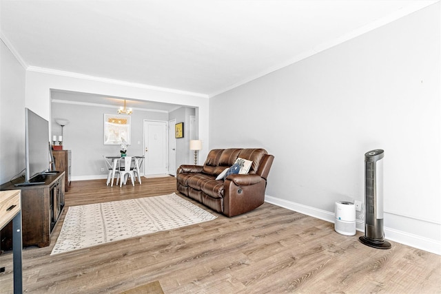 living area featuring baseboards, wood finished floors, and a notable chandelier