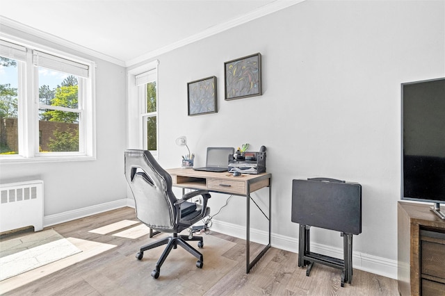 office featuring crown molding, baseboards, radiator heating unit, and wood finished floors