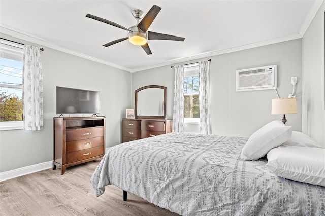 bedroom featuring crown molding, baseboards, a wall mounted AC, a ceiling fan, and light wood finished floors
