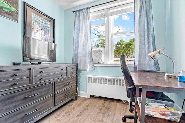 office area featuring light wood-style floors, radiator, and baseboards