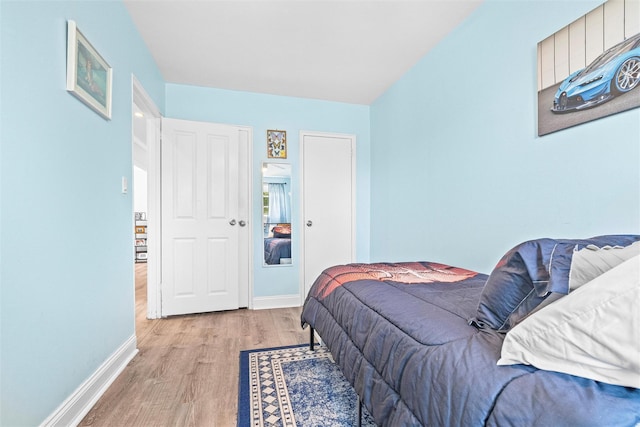 bedroom featuring baseboards and light wood-type flooring