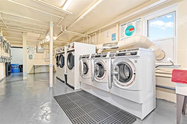 shared laundry area with washing machine and clothes dryer