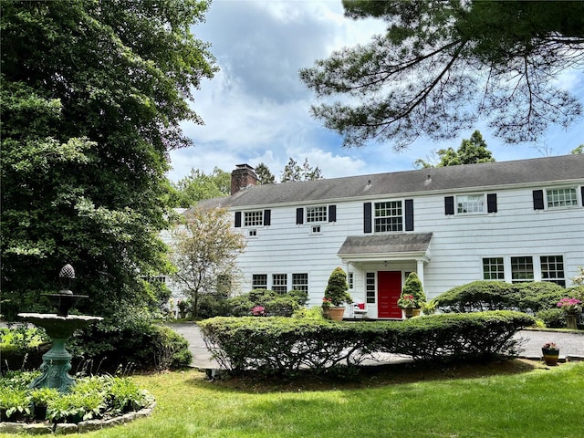 12 W Mall Dr, West Hills, NY 11743 - colonial inspired home featuring a chimney and a front lawn