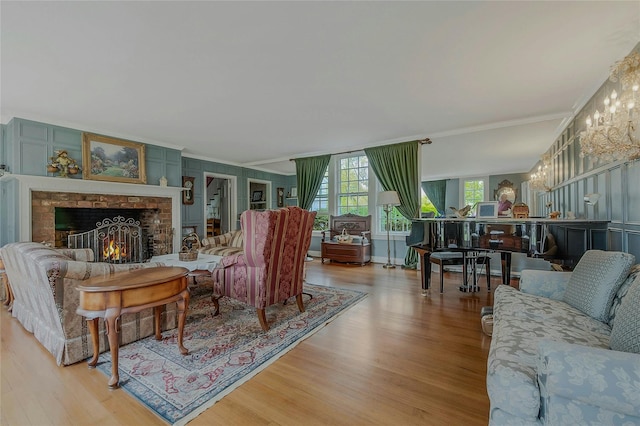 12 W Mall Dr, West Hills, NY 11743 - living room featuring wood finished floors, crown molding, and a brick fireplace